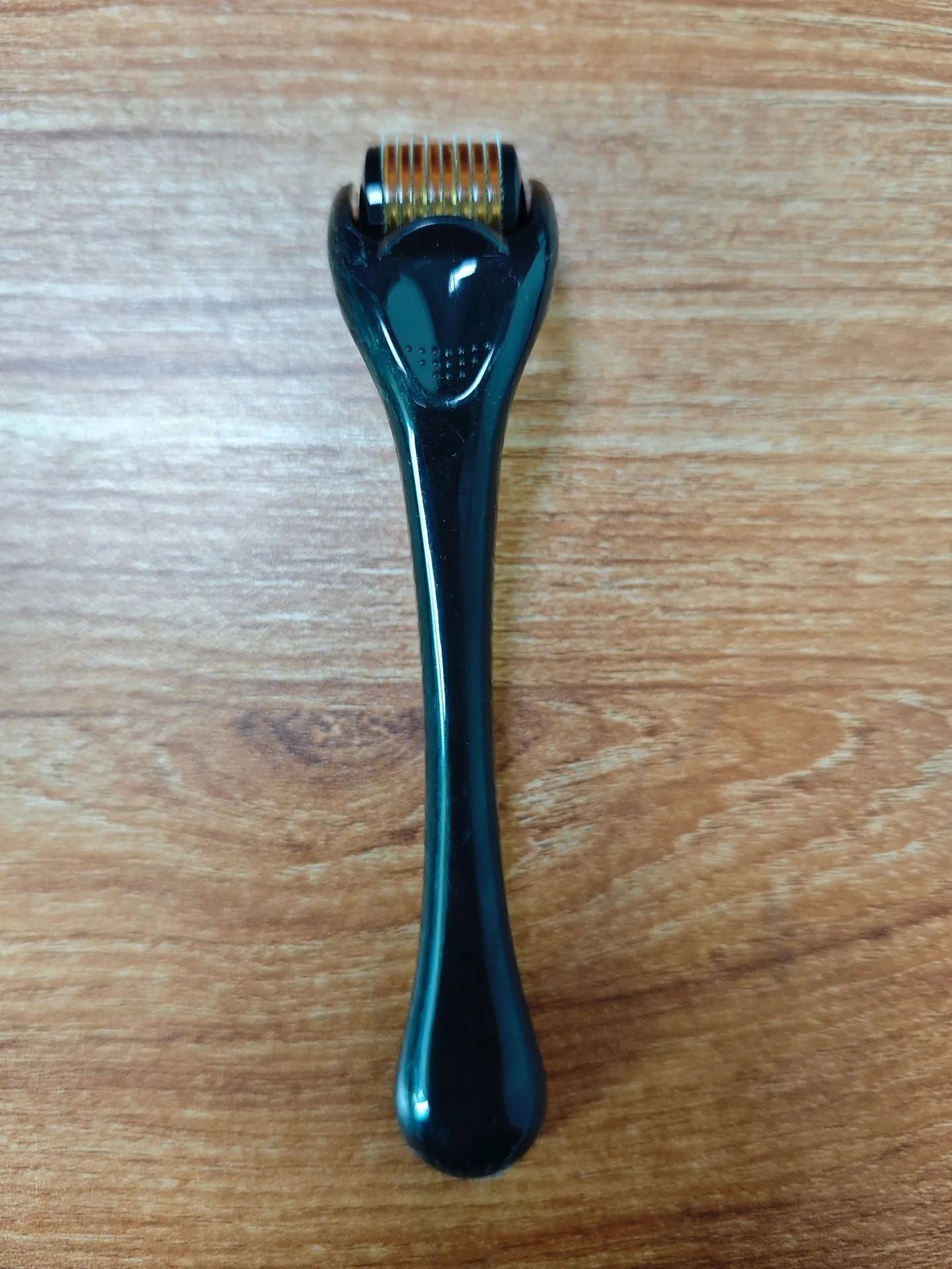 540 needle derma roller with black handle and coloured wheel, showing 0.25mm 0.3mm size options for micro-needling.
