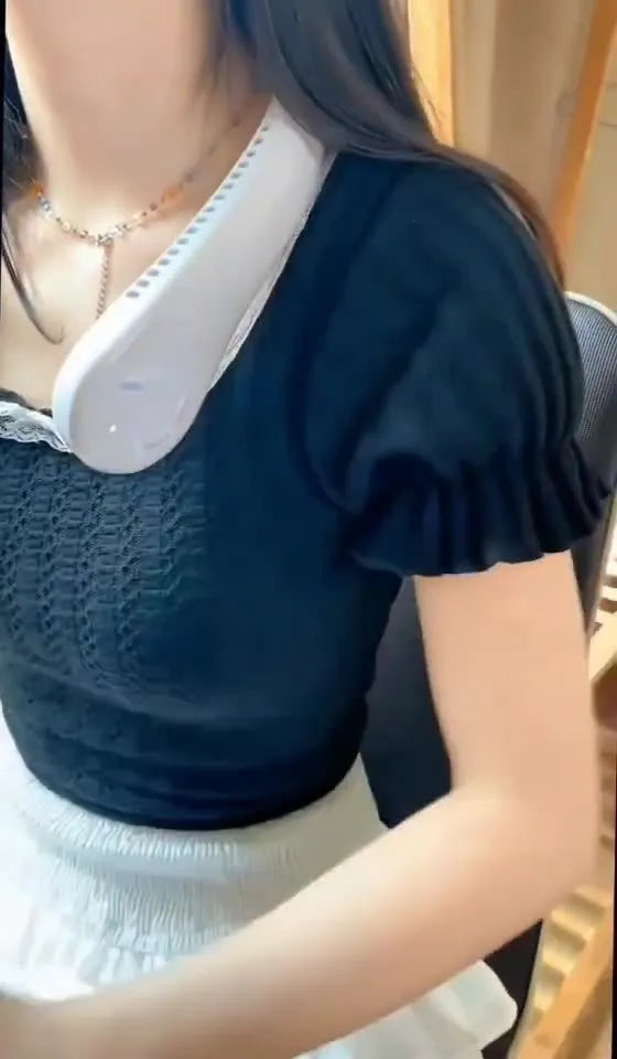 Pink portable bladeless neck fan being worn, showing USB charging port and control button.