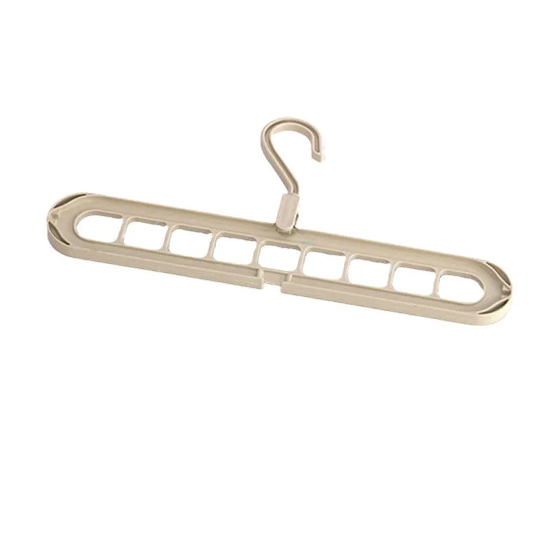 Plastic nine-hole hanger in beige colour showing seamless folding design for trousers