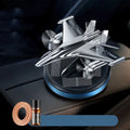 Silver solar powered rotating fighter jet perfume ornament on car dashboard with aluminium alloy construction