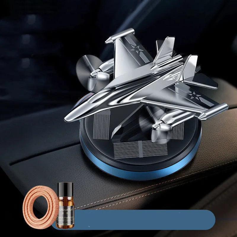 Silver solar powered rotating fighter jet perfume ornament on car dashboard with aluminium alloy construction