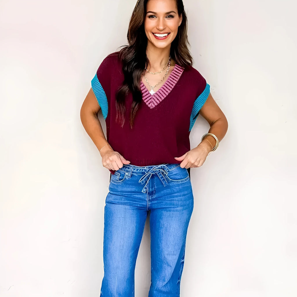 Burgundy loose-fitting women's V-neck sweater with light contrast trim on the neckline and cuffed short sleeves.