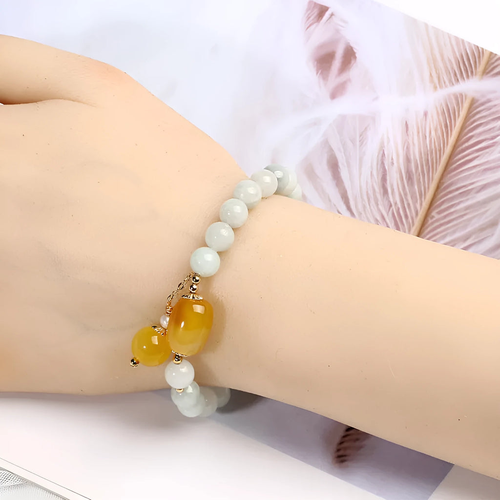 Women's bracelet with 7.5mm round agate beads and hanging tassel in 14K gilded finish