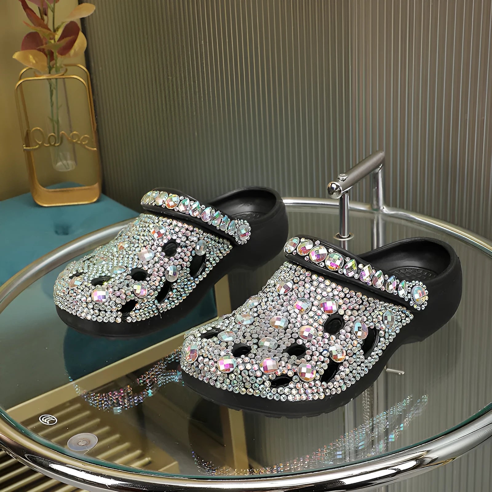 Black platform sandals for women with rhinestone decoration and a hole design upper on a white background.