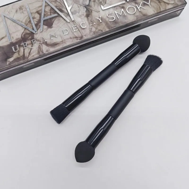 Double-headed black makeup brush with angled sponge and concealer brush on wooden handle