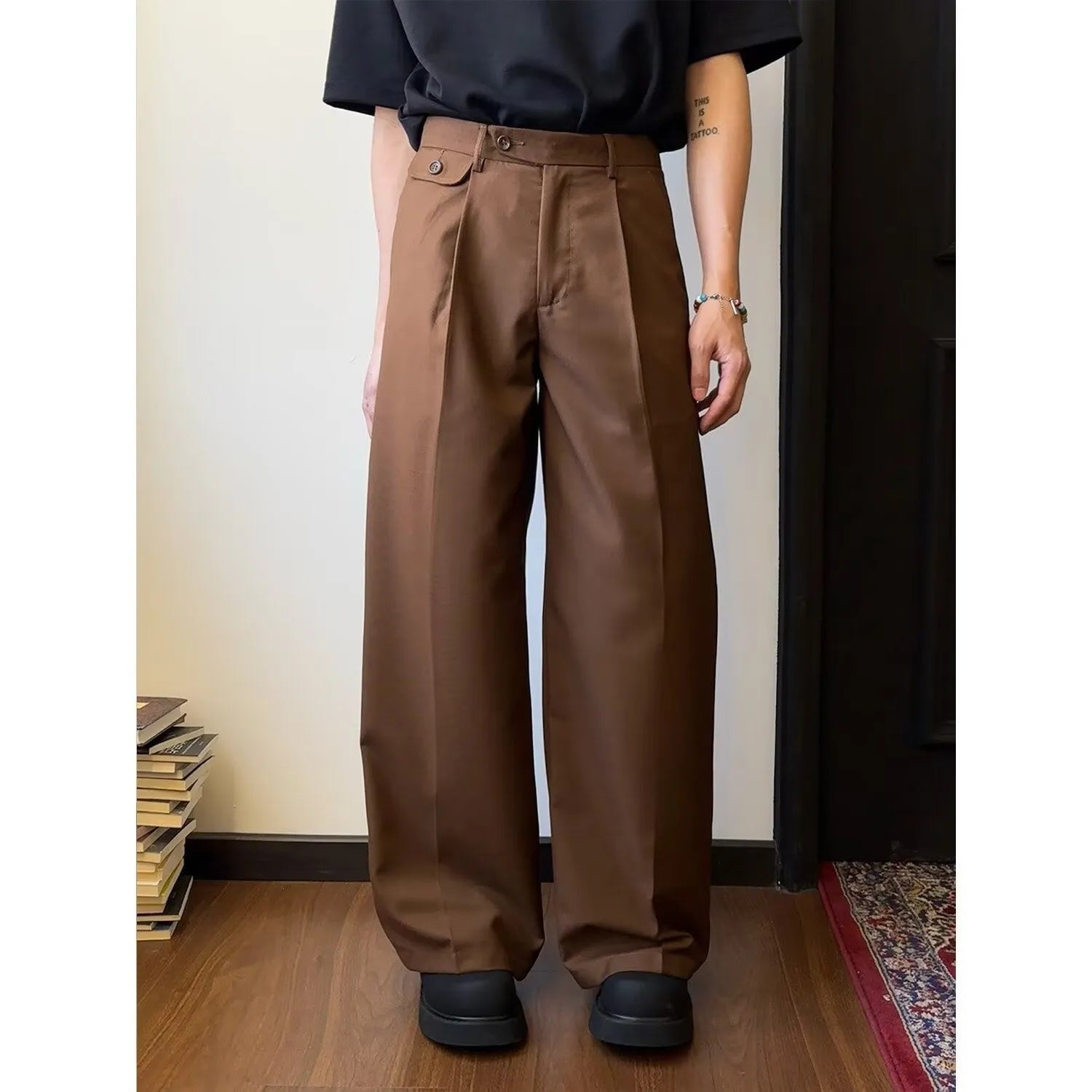 Men's brown straight-leg loose wide-leg casual suit trousers laid flat.