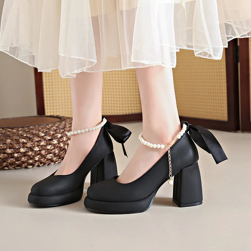 Beige women's Mary Jane shoes with chunky heel, ankle strap buckle, and pearl decoration on round toe