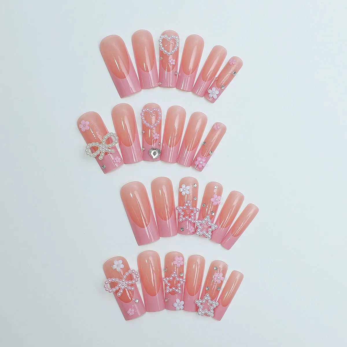 Super long pointed water pipe style false nails with French tip, love heart and bow design in colour XB-70-48.
