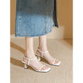 Black square toe high heel sandals with thick heel and one-line buckle strap on a white background