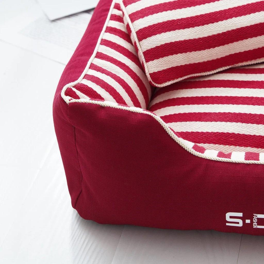 Navy stripe washable dog kennel mat with removable cover and matching mini pillow on a light background