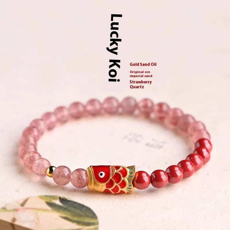 Close-up of a women's bracelet with purple cinnabar and pink strawberry quartz beads in a retro design.