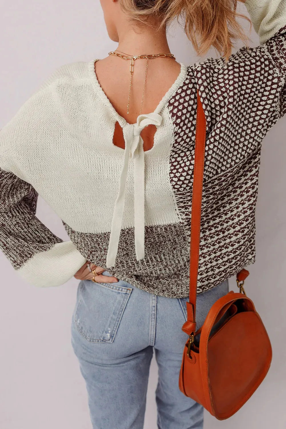 Dark khaki women's loose sweater with back tie closure and drop shoulders.