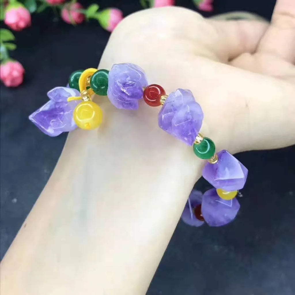 Close-up of a natural-shaped amethyst bead bracelet for women with a fu charm.