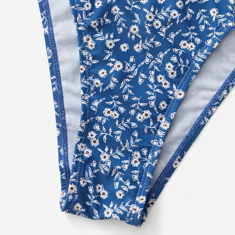 Blue three-piece women's swimsuit set with separate top and shorts on a mannequin.