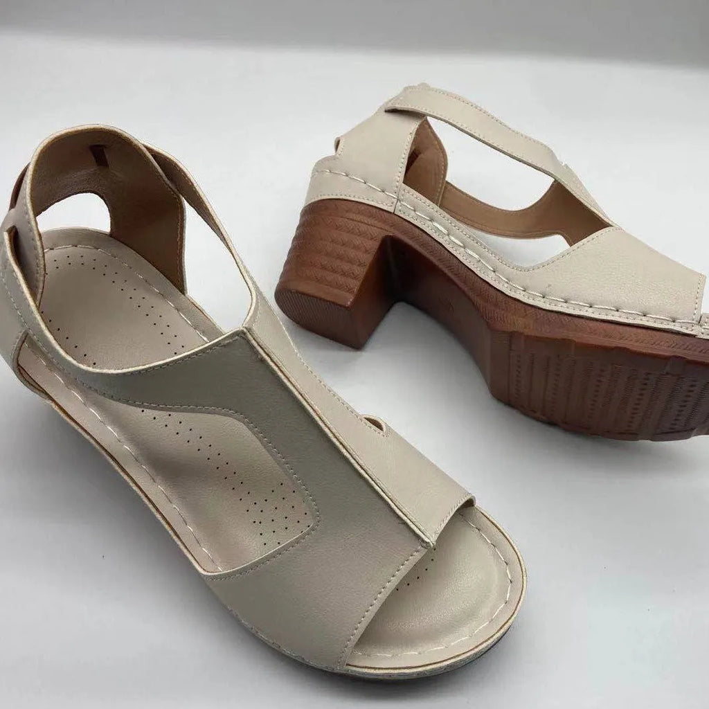 Women's beige peep toe wedge sandals with Roman ankle straps and a buckle closure on a low heel.