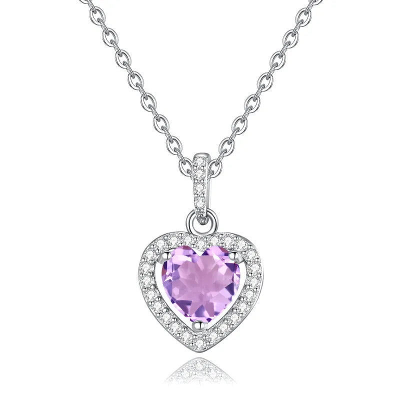 Women's sterling silver heart pendant necklace with a coloured gemstone on an adjustable chain.