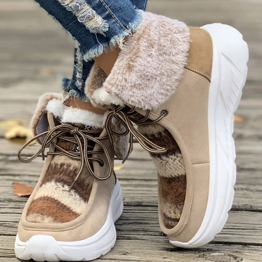 Women's beige suede lace-up snow boots with a thick rubber sole and plush lining on a white background.