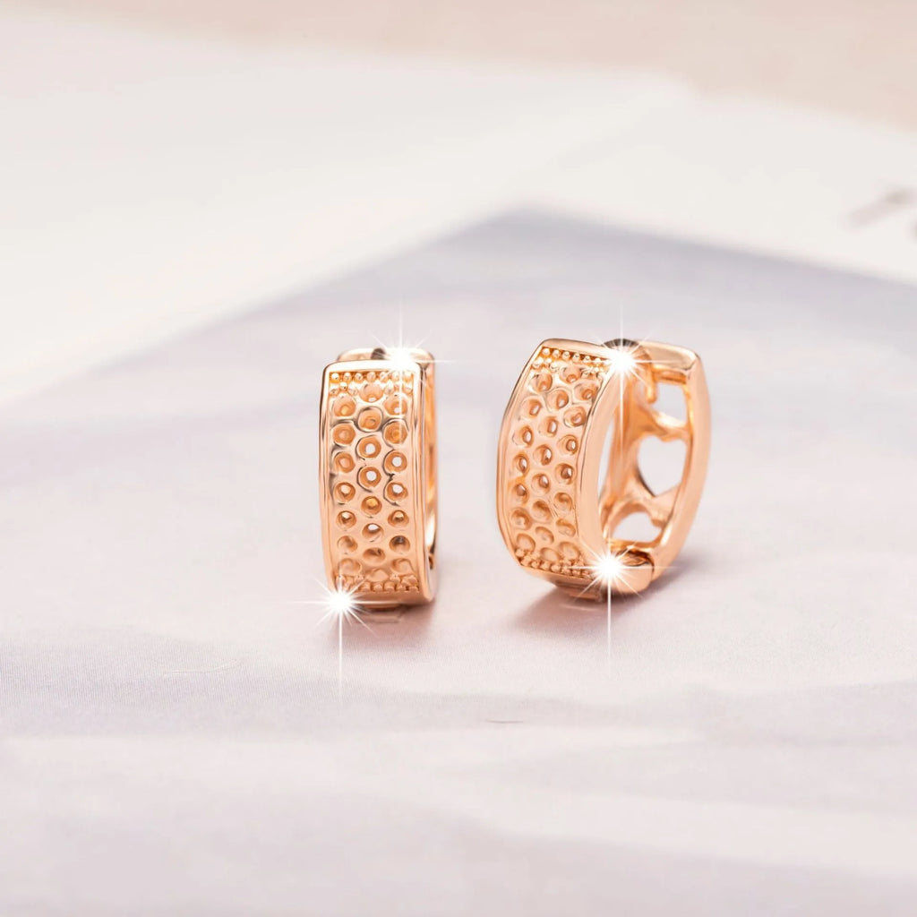 Rose gold electroplated women's earrings with hollow heart-shaped design and circular overall shape