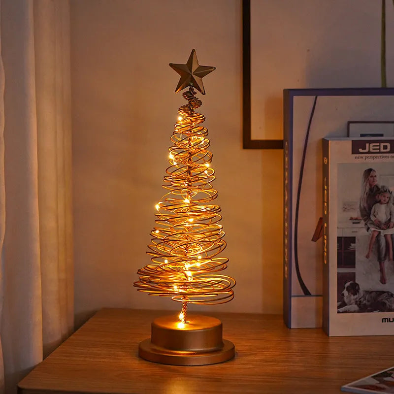 LED Christmas tree spiral light ornament with warm white glow on a table, gold finish