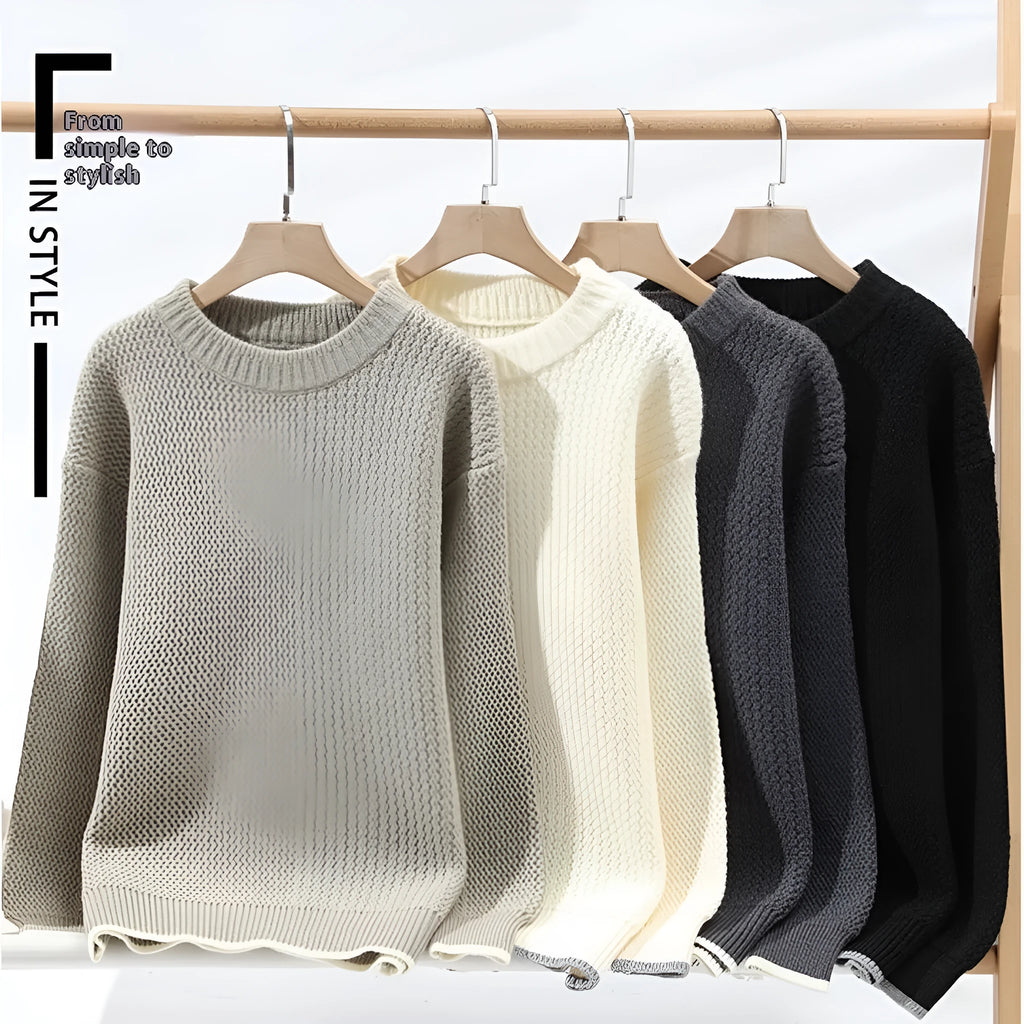 Man wearing a loose grey round neck pullover sweater, casual autumn outfit