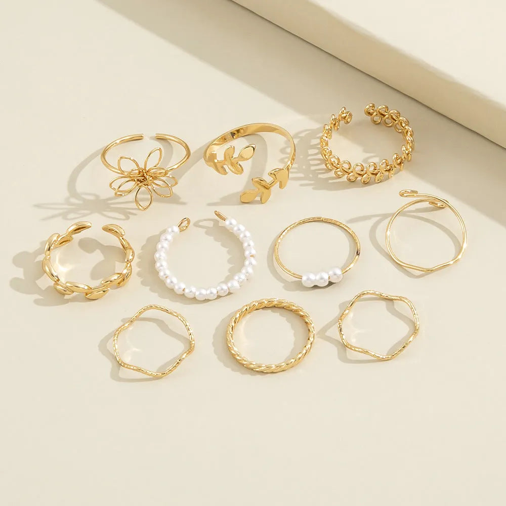 Women's openwork flower ring set with glossy gold finish and floral design