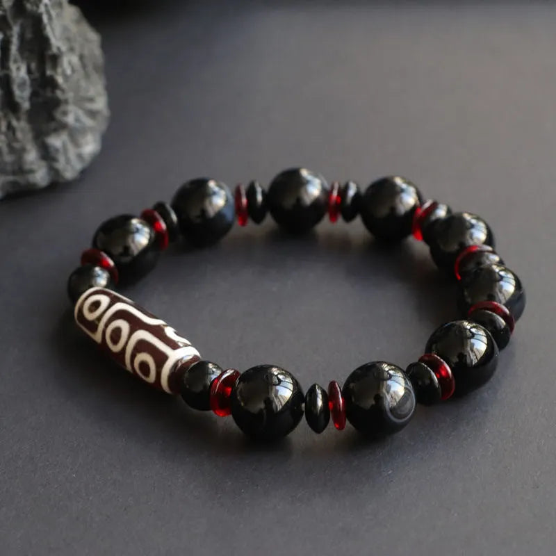 Black agate Dzi bead bracelet with geometric design and hand-woven construction
