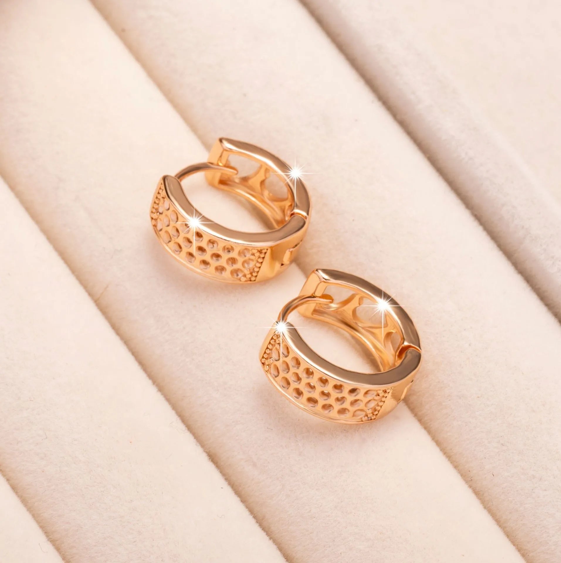 Rose gold electroplated women's earrings with hollow heart-shaped design and circular overall shape