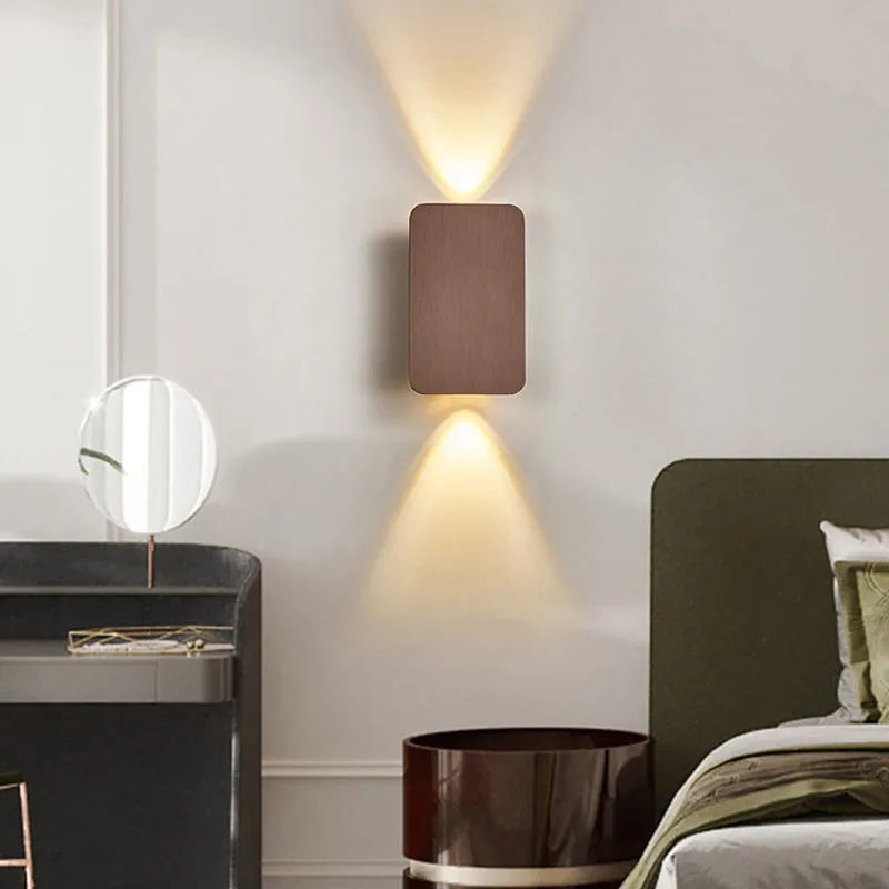 Minimalist modern Nordic metal LED wall lamp in black, mounted on a wall.