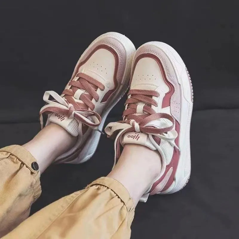 Women's pink low top sneaker with a rubber platform sole on a white background.