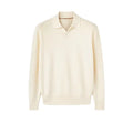 Man wearing a milky white pure wool polo sweater with a lapel collar.