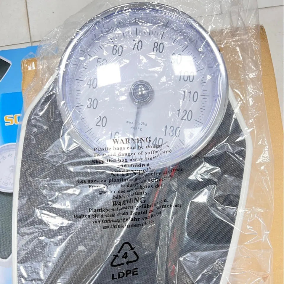 Black mechanical body weight scale with large dial showing weight measurements