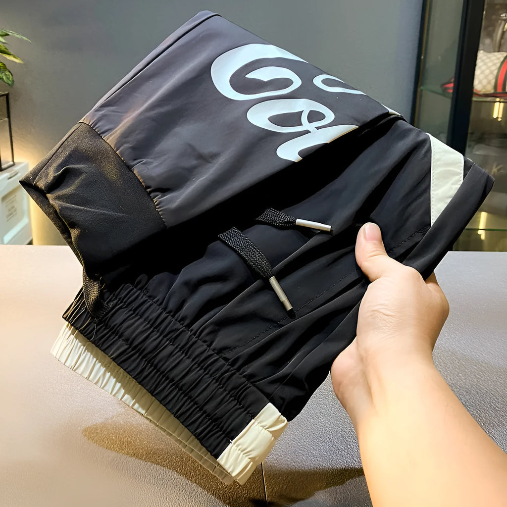 Men's black ultra-thin ice silk ankle banded cropped casual trousers on hanger