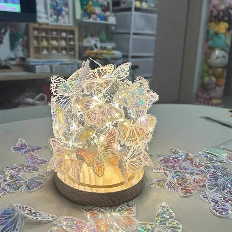 Butterfly night light with glass shade on raw wood base, measuring 12x15cm