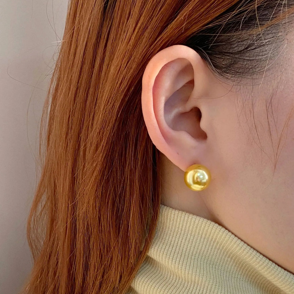 Large geometric pearl stud earrings with retro styling and eight-point star detail in silver