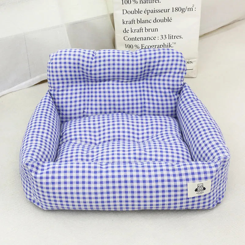 Grey and blue plaid car-mounted removable pet travel nest for dogs on a car seat