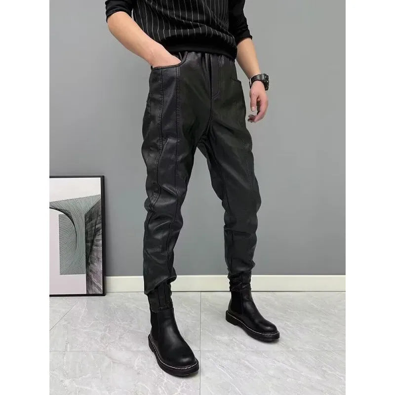 Black PU leather motorcycle takeaway pants with cuffs, tapered leg, and mid-rise waist, on a model