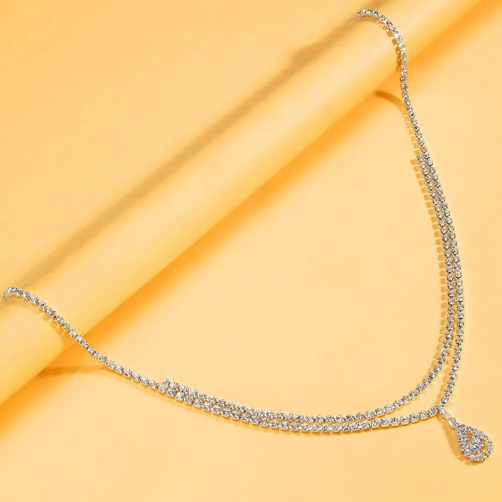 Gold rhinestone waist chain with tassel pendant and lobster buckle, 115cm length