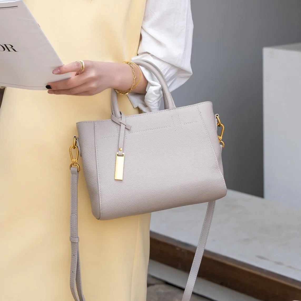 Portable genuine leather women handbag in soft cowhide with horizontal square shape and single strap, available in multiple colours