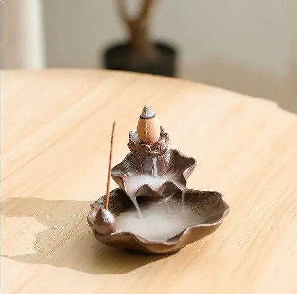 Square ceramic reverse flow incense burner with purple clay finish and lotus plum blossom decoration.