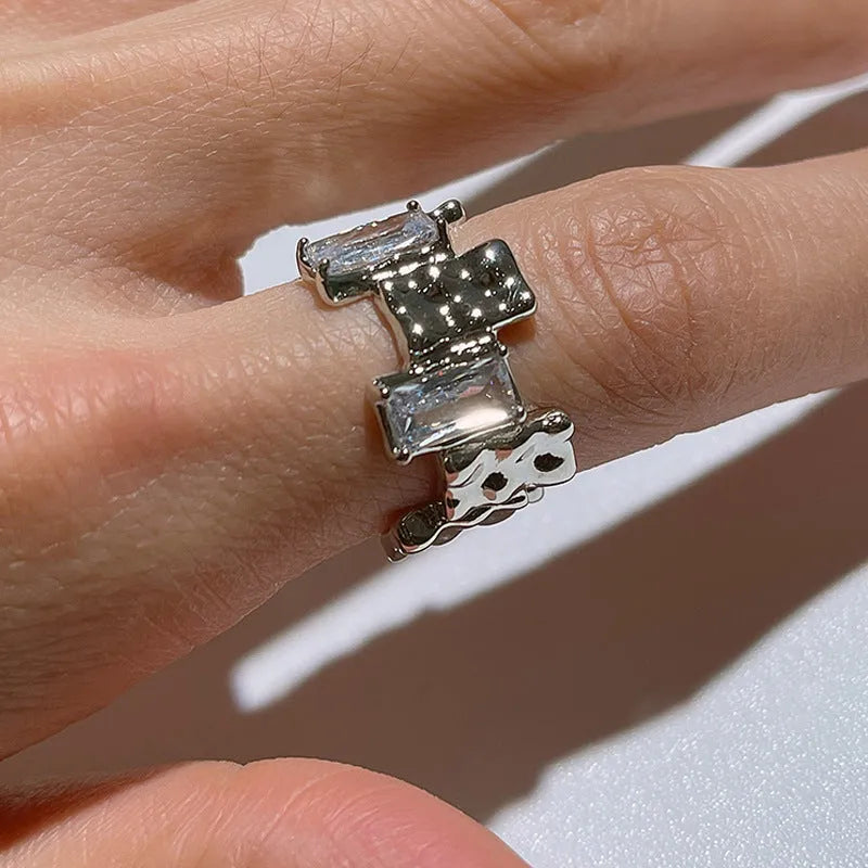 Silver geometric cross ring with zircon detail and open retro design