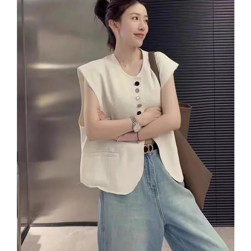 Women's loose fit polyester vest in milky white colour with pockets.