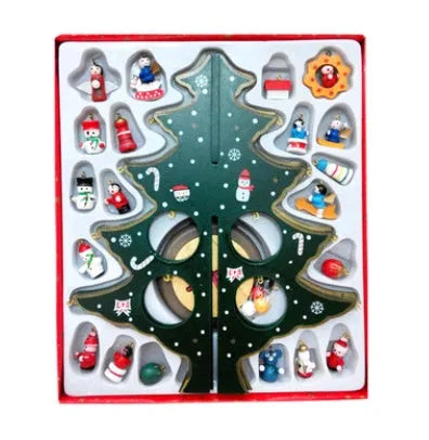 Set of three hand painted wooden Christmas trees in green on a table, largest 36cm tall