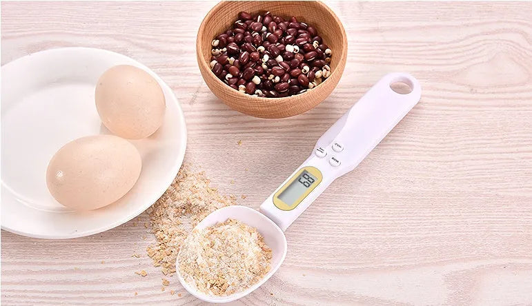 Household electronic measuring spoon scale with ABS plastic body and digital display on a kitchen surface