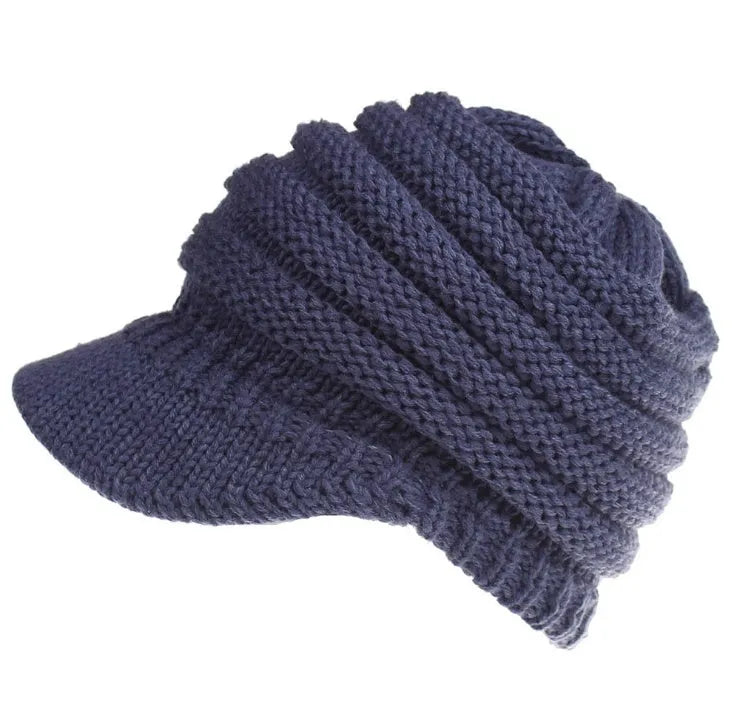 A soft grey acrylic knitted beanie for women, worn over a ponytail.