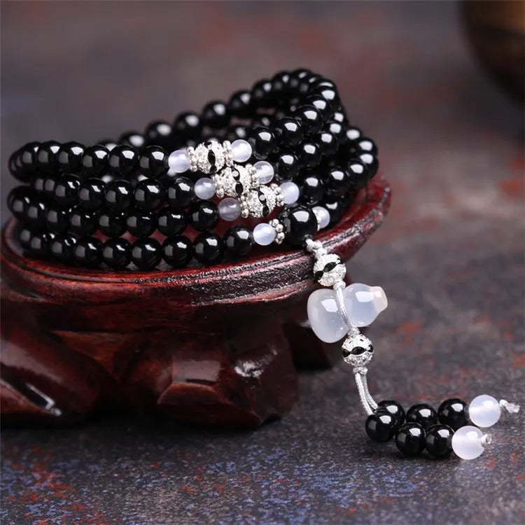 Natural black agate 108 beads bracelet on a flat surface, geometric beads, unisex fashion OL style