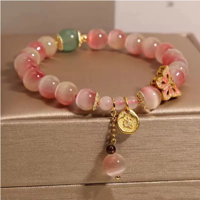 Pink opal butterfly women's bracelet with electroplated finish, Chinese style, on display