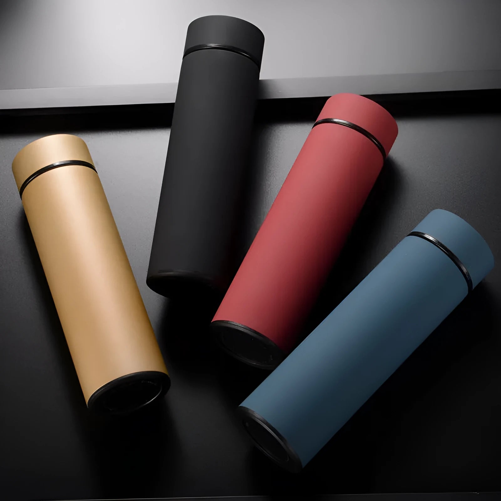 Stainless steel vacuum insulated water bottle in black, red, gold, or blue with 450ml capacity.