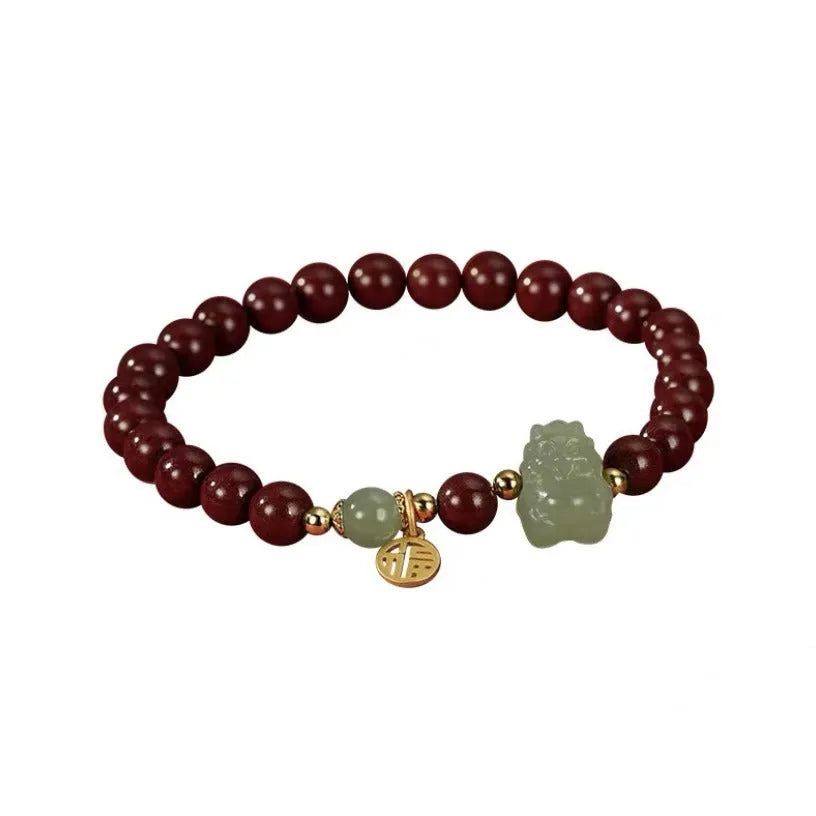 Natural Hetian jade cinnabar bracelet with 8mm beads, Emperor Sandstone style, on display