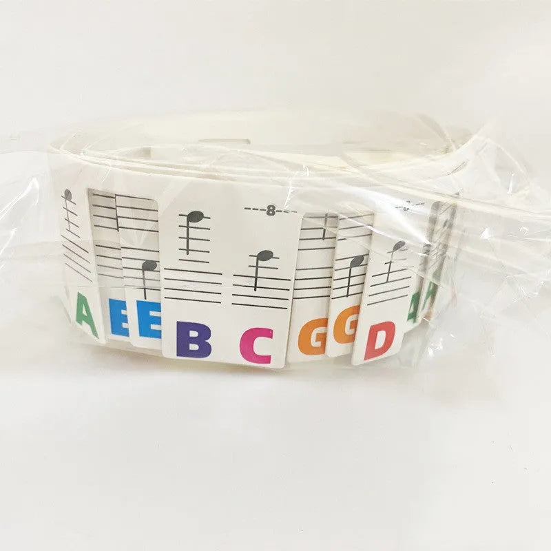 Piano keyboard stickers showing black music notes and colour note bars for 88-key instrument learning