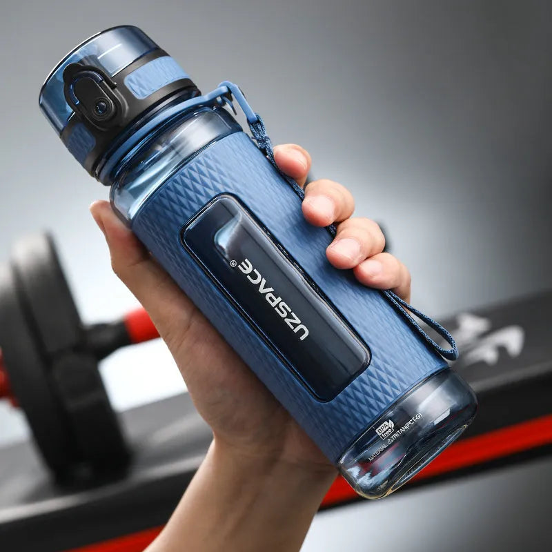 Portable sport water bottle in blue, copolymer polyester plastic, 1100ml capacity, with black cap.